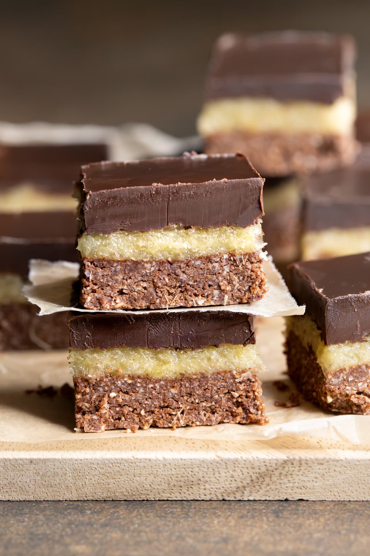 Pieces of dark chocolate ginger slice separated with baking paper