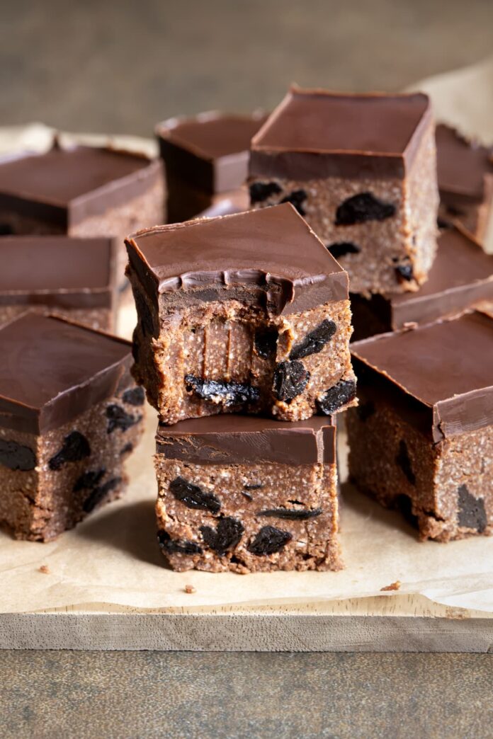 Pieces of healthy chocolate sour cherry slice stacked on top of each other