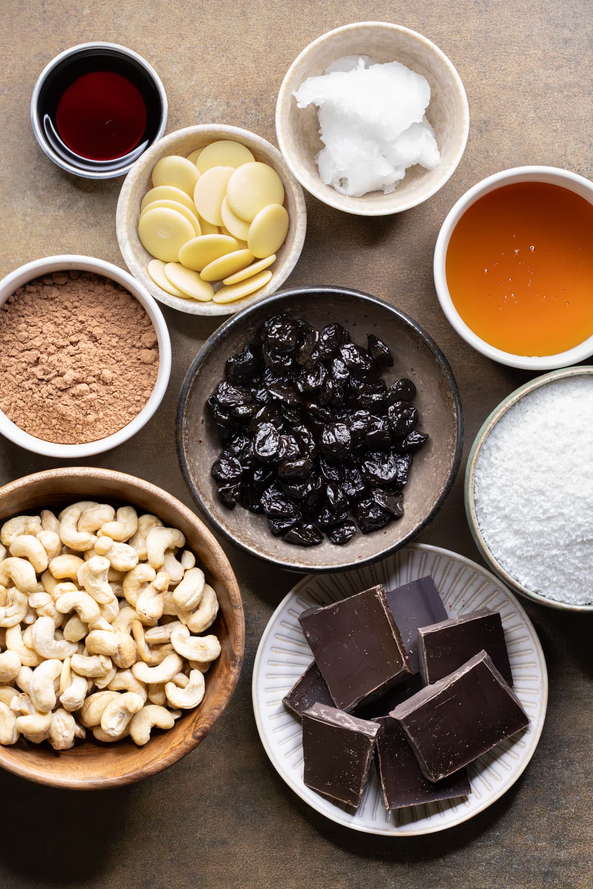 Ingredients for chocolate sour cherry slice arranged in small bowls