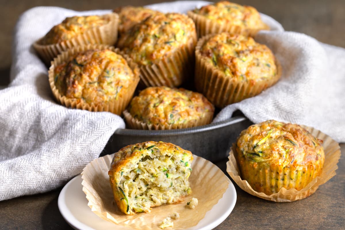 Easy buckwheat zucchini muffins with a bite taken out of one muffin