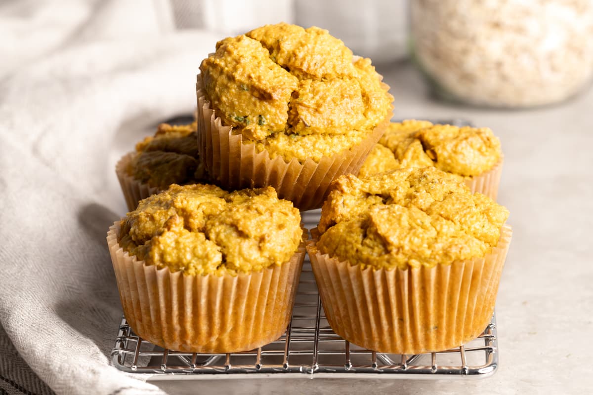 Easy savory sweet potato muffins with fresh parsley and rolled oats in the background