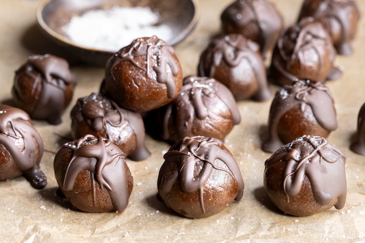 Easy choc mint whey protein balls with a chewy texture arranged on a sheet of baking paper