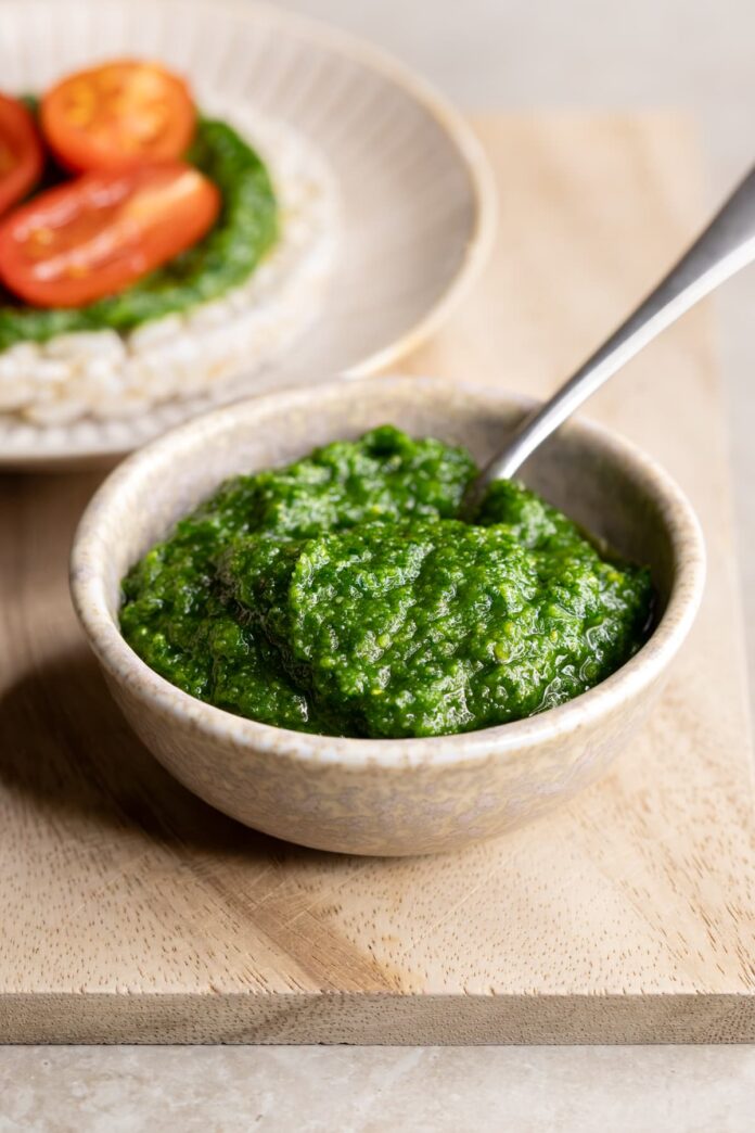 Parsley pine nut pesto served as a spread with fresh tomato