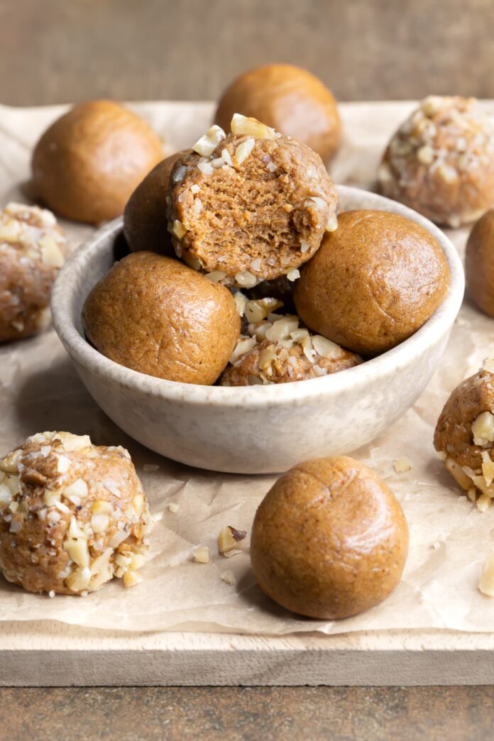 Coffee whey protein balls in a bowl stacked on top of each other