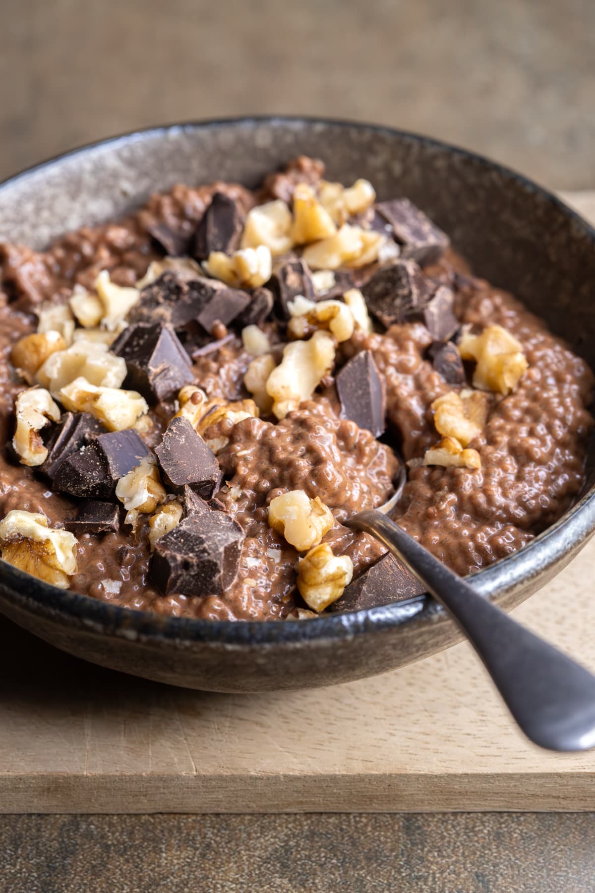 Vegan chocolate brownie batter chia pudding topped with dark chocolate and walnuts