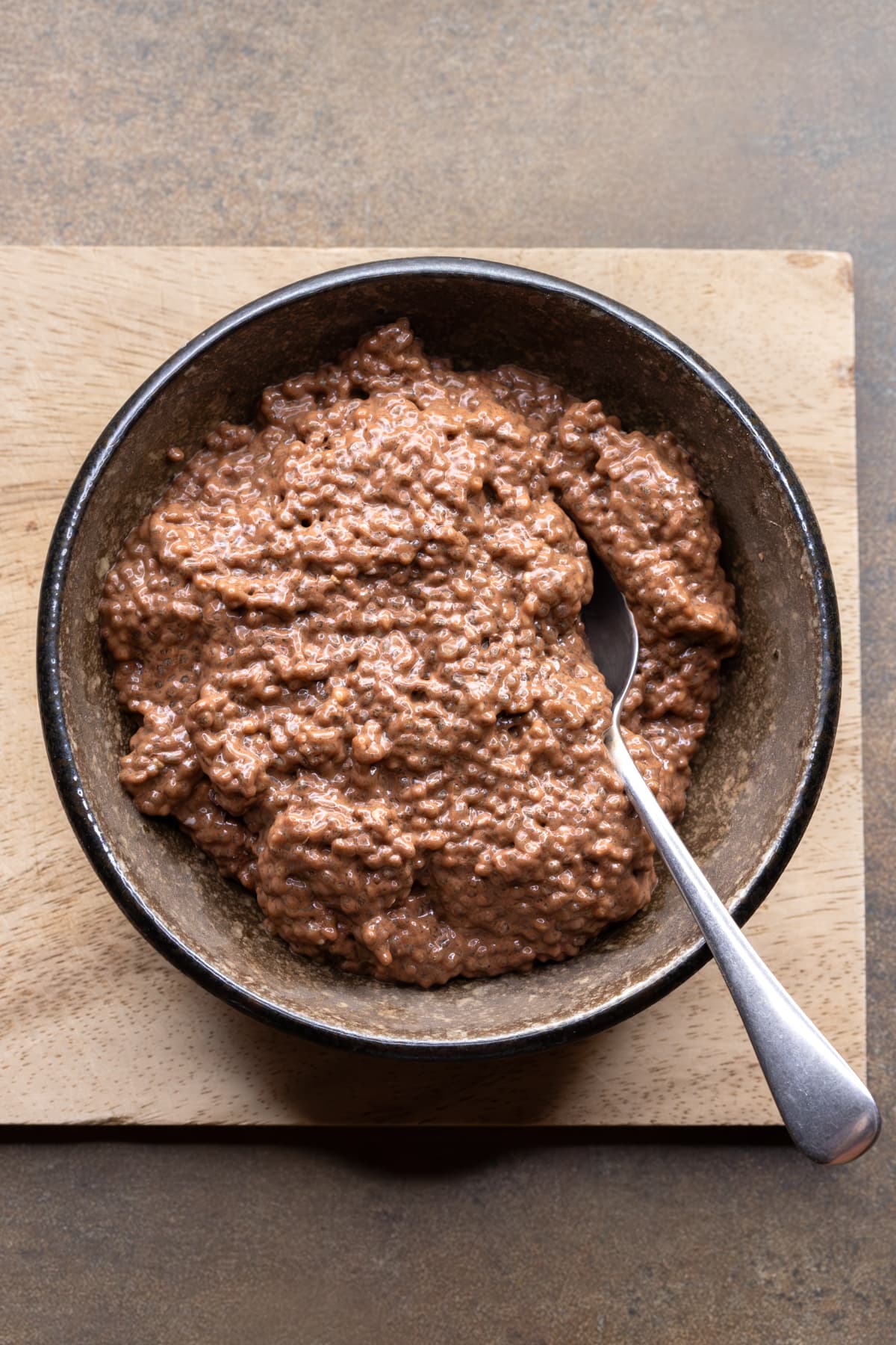 Chocolate chia pudding served in a bowl with a spoon