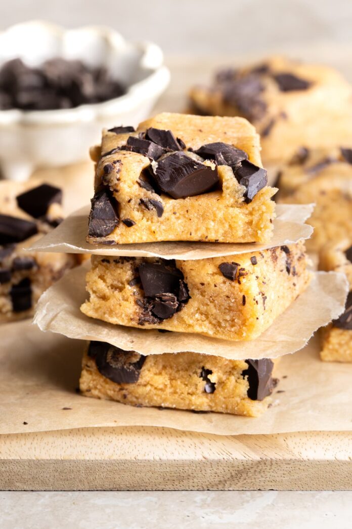 Gluten-free cookie dough protein bars with collagen powder stacked on top of each other