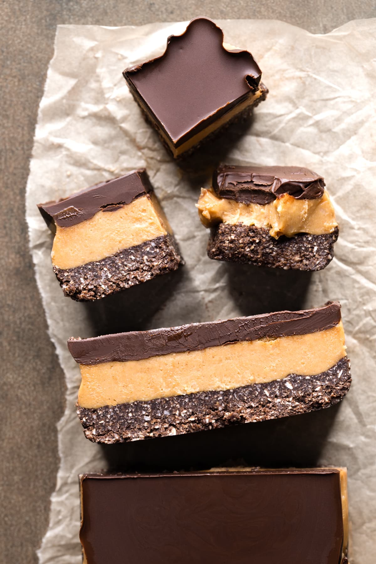 Easy no-bake vegan caramel slice cut into bars on a sheet of baking paper