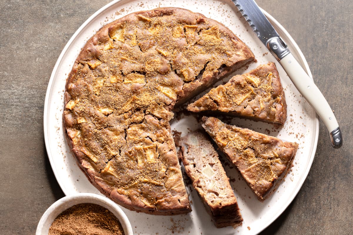 Gluten-free and nut-free apple cake cut into slices on a white plate