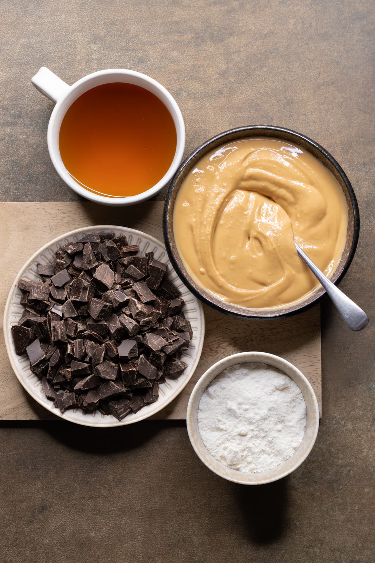 Ingredients for vegan peanut butter bars set out in bowls