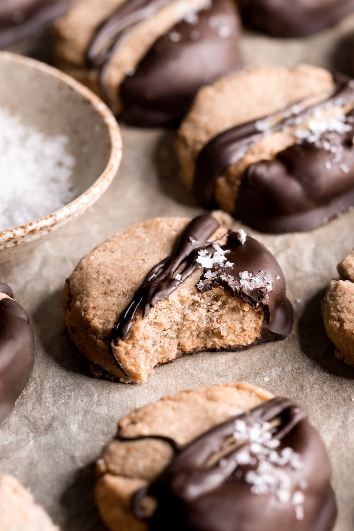 Gluten-free almond olive oil shortbread cookies with bite taken out of one cookie