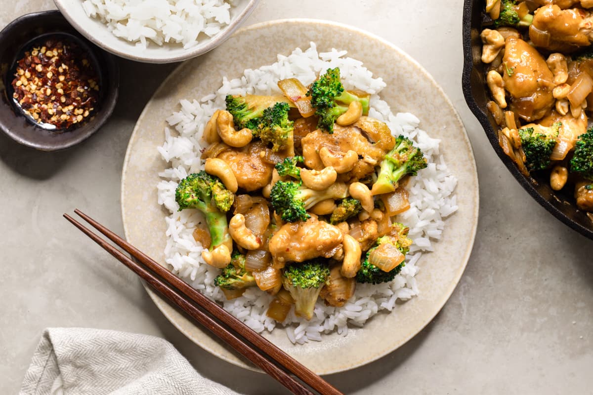 Cashew chicken, broccoli and white rice served on a plate