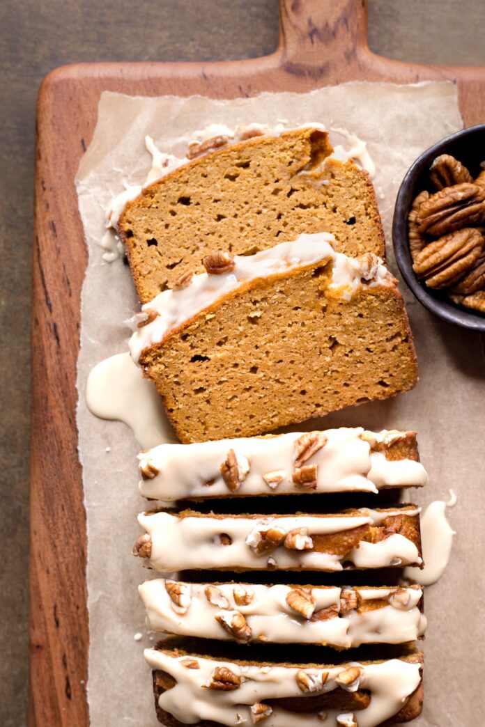 Gluten-free pumpkin bread without dairy cut into slices with maple glaze and pecan nuts