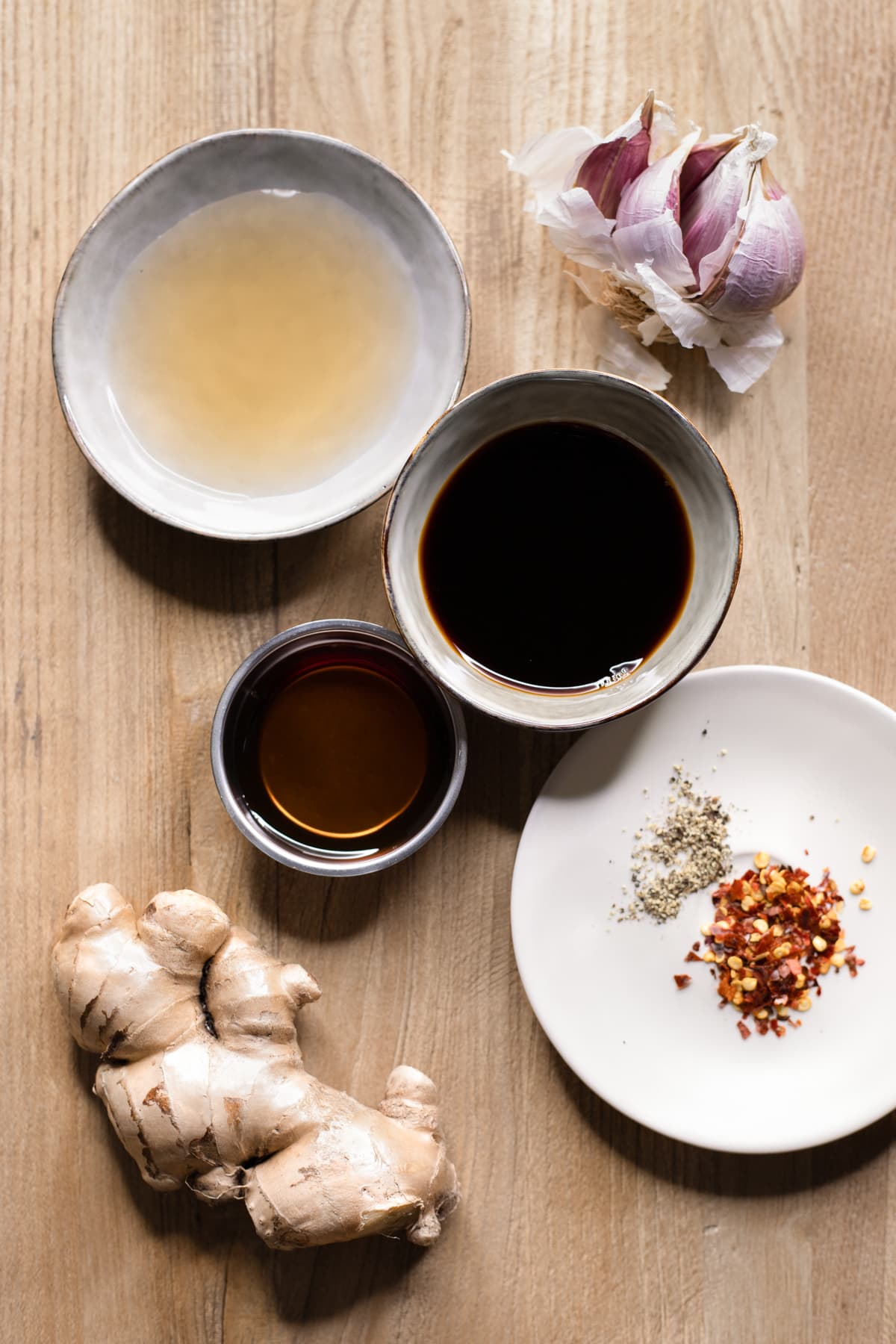 Ingredients for gluten-free stir fry sauce set out on a wooden board