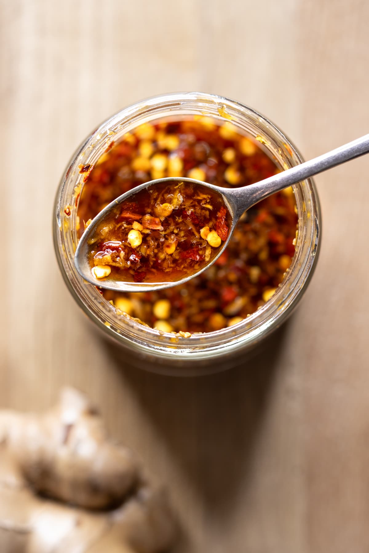 Stir fry sauce for gluten-free cashew chicken in a jar with a piece of fresh ginger