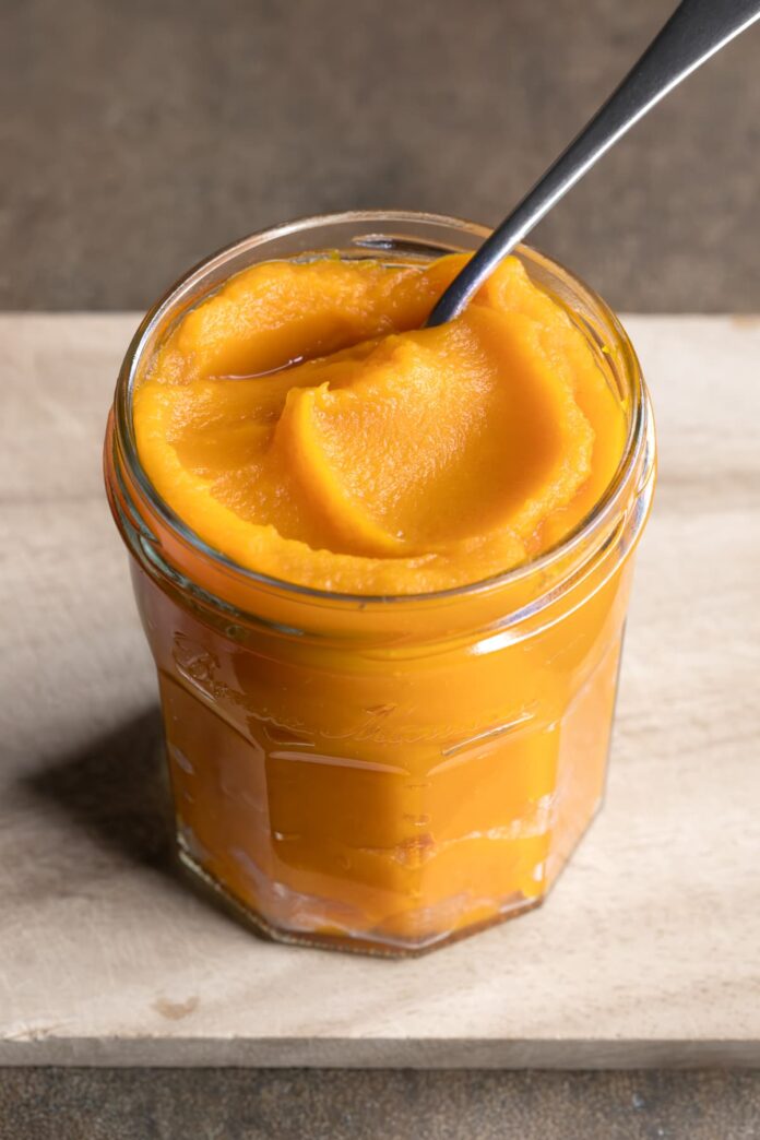 Pumpkin puree spooned in a jar