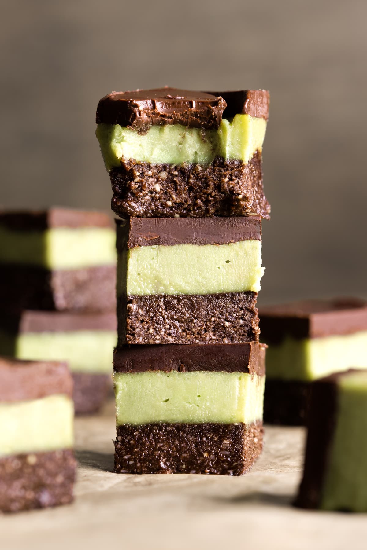 Pieces of easy vegan no-bake chocolate mint slice stacked on top of each other