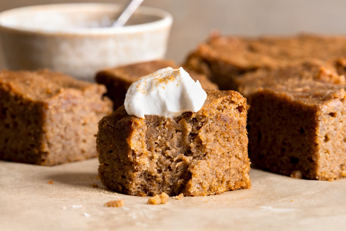 A square of gingerbread cake served with whipped coconut cream