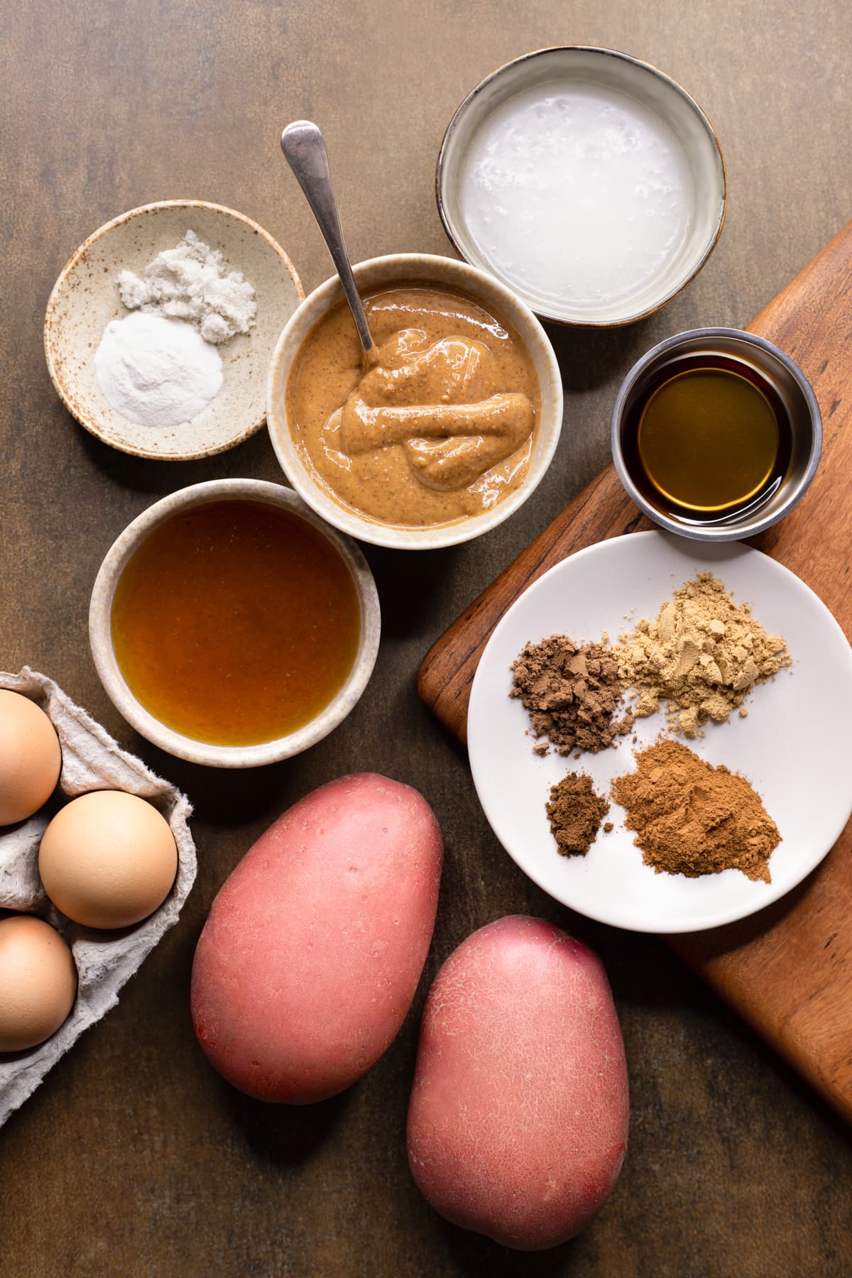 Ingredients for gluten-free gingerbread cake set out in bowls