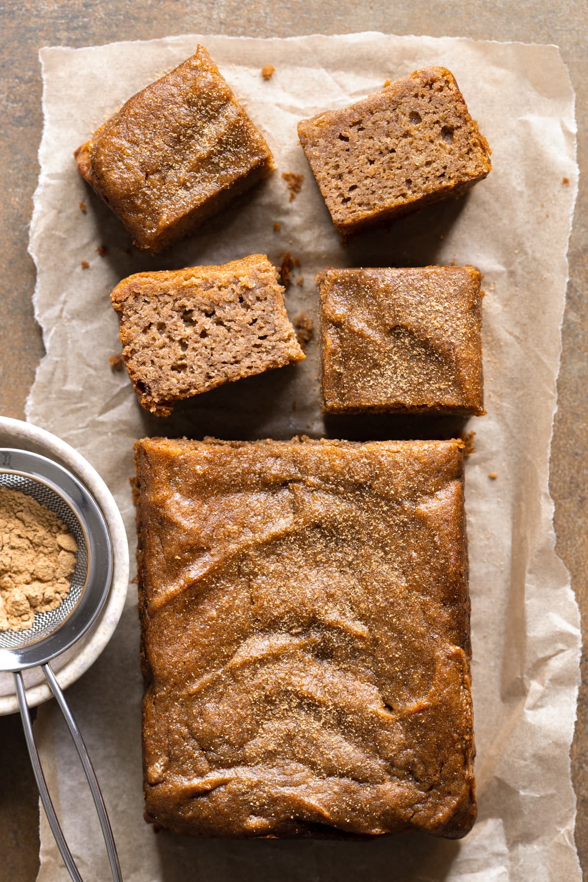 Gingerbread cake cut into squares and sprinkled with ground ginger