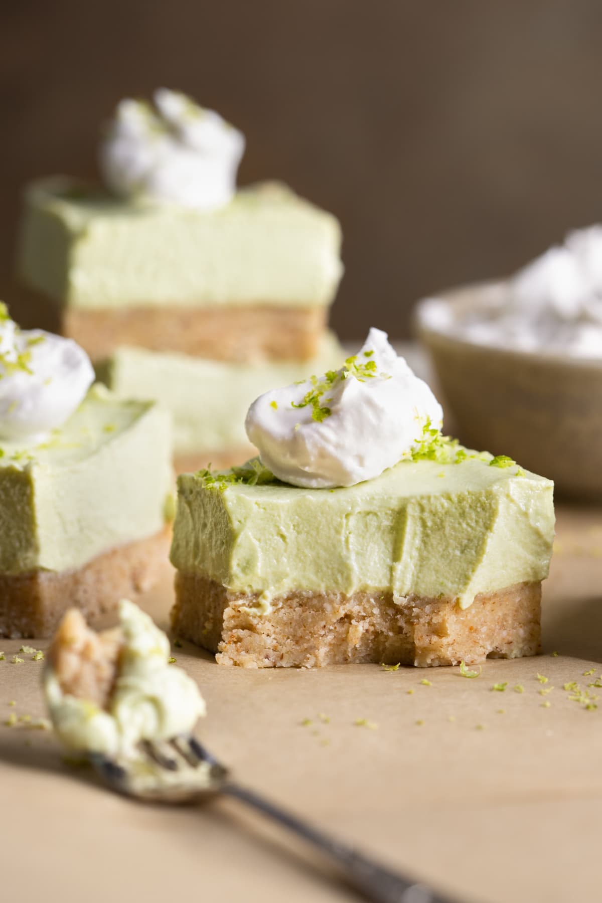 Gluten-free no-bake vegan lime cheesecake bars with a bite taken out of one bar