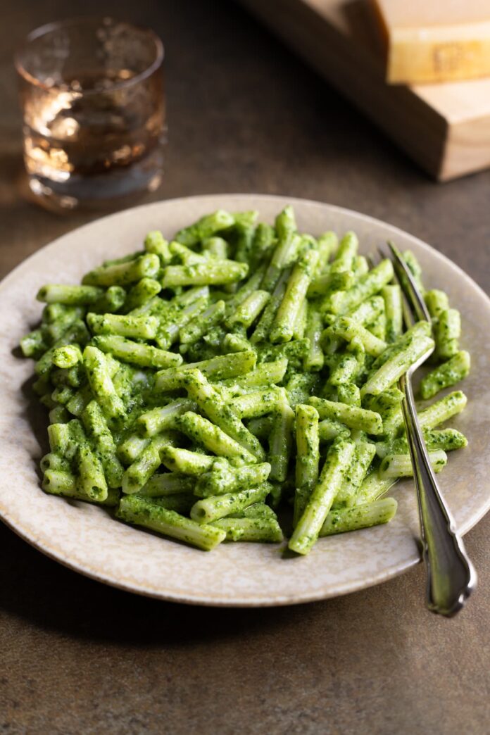 Gluten-free parsley pesto pasta with cashew nuts served in a bowl