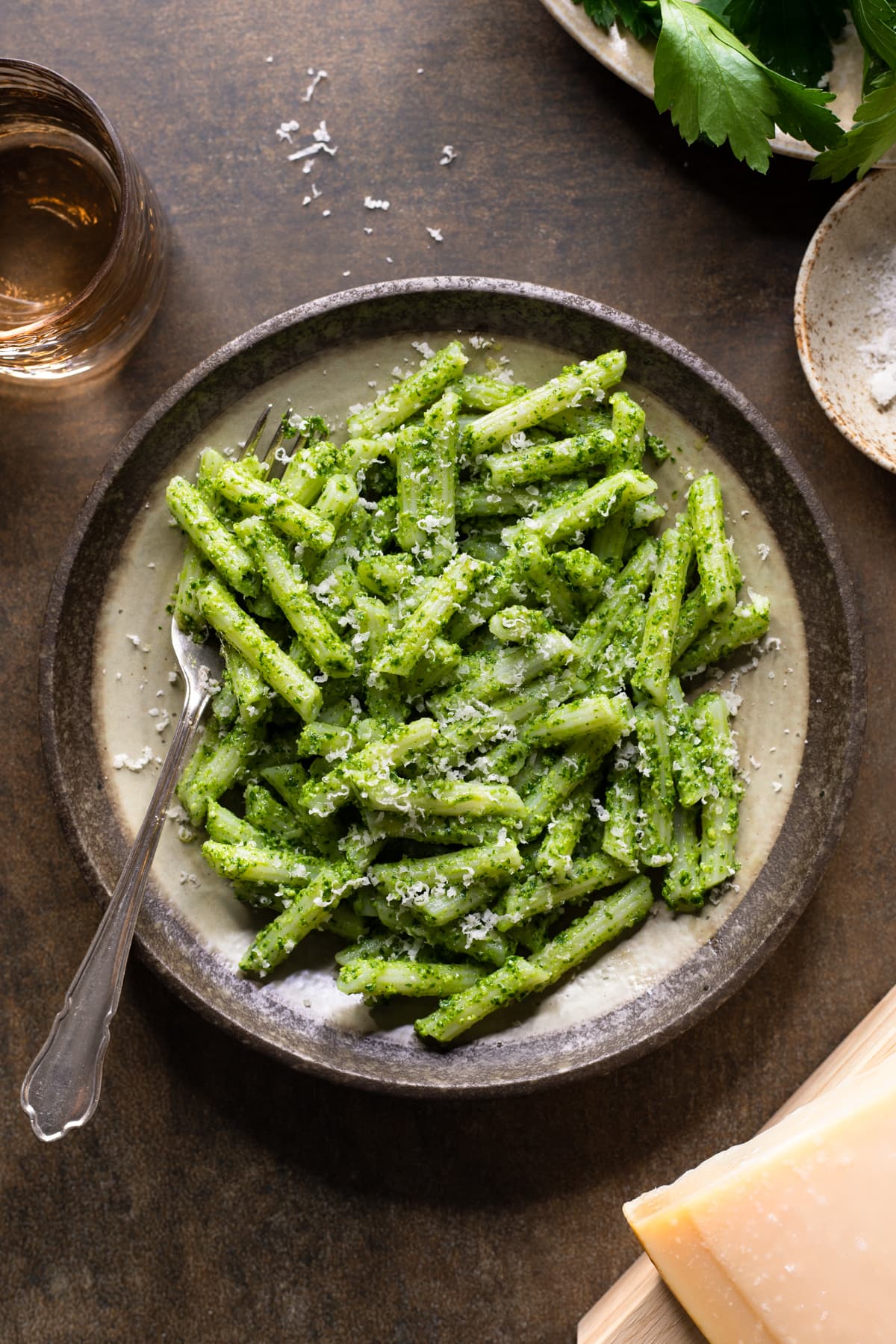 Gluten-free parsley pesto pasta with cashew nuts served on a plate