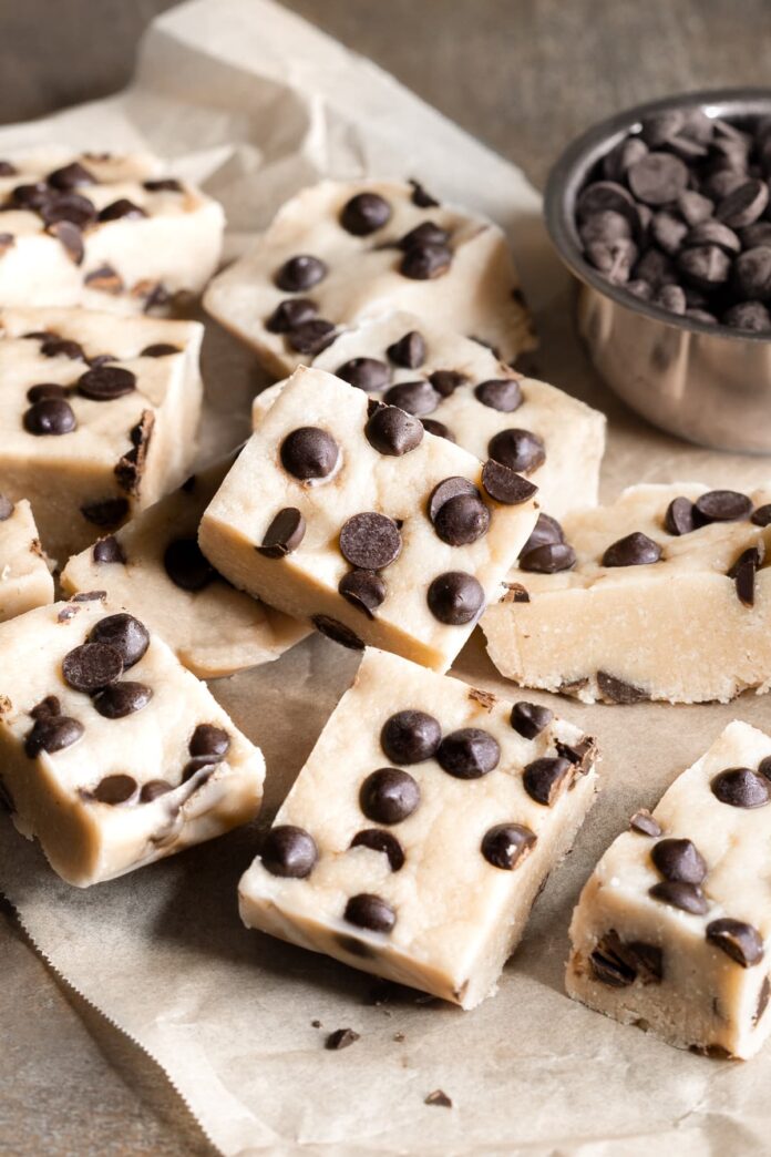 Nut-free cookie dough protein bars with chocolate chips arranged on a sheet of baking paper