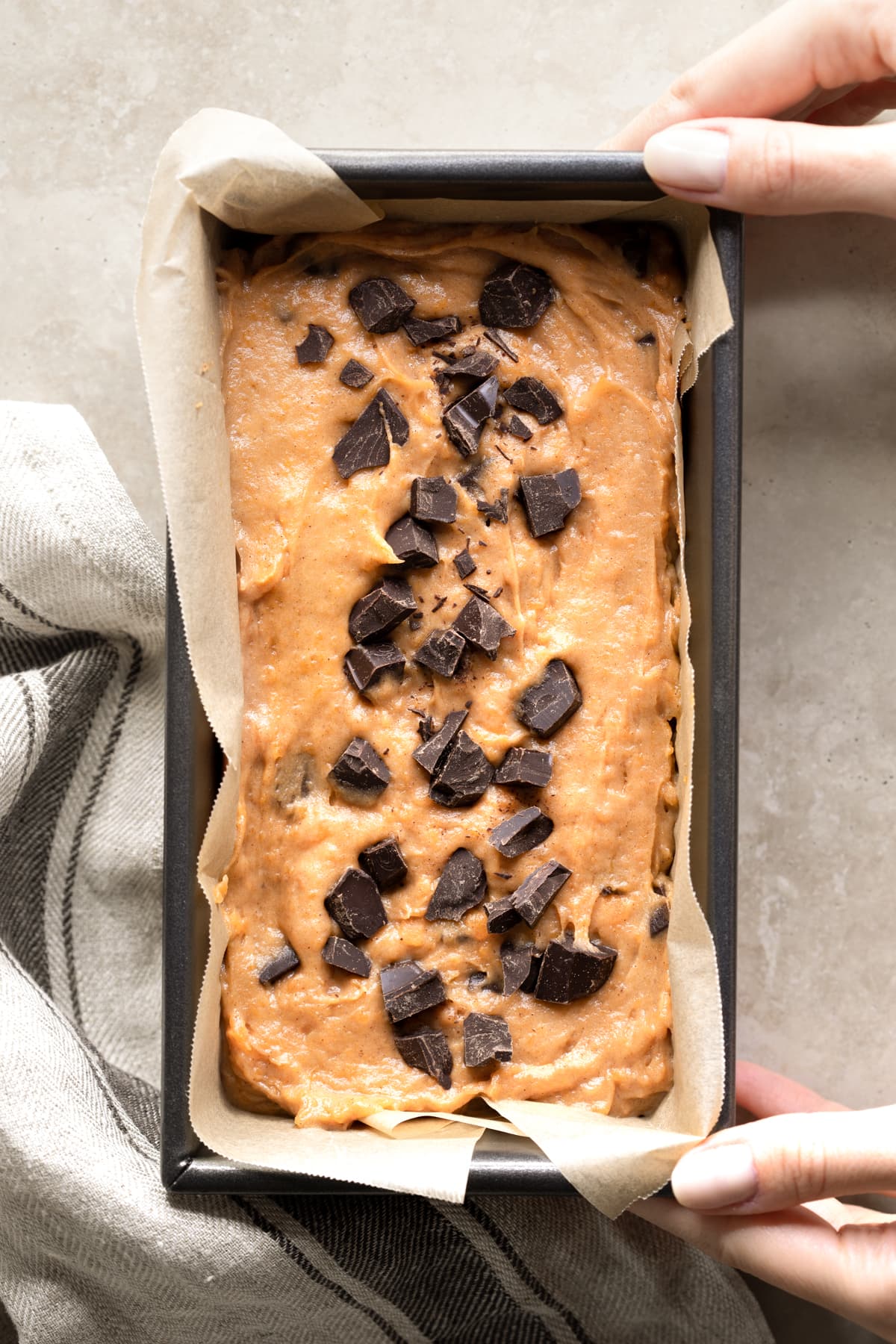 Vegan sweet potato bread batter in a loaf tin with chocolate chips