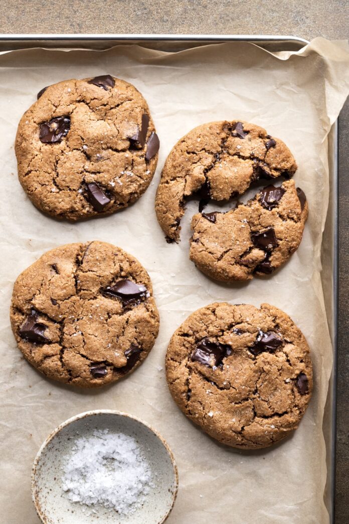 Chocolate chip cookies on a baking tray with sea salt