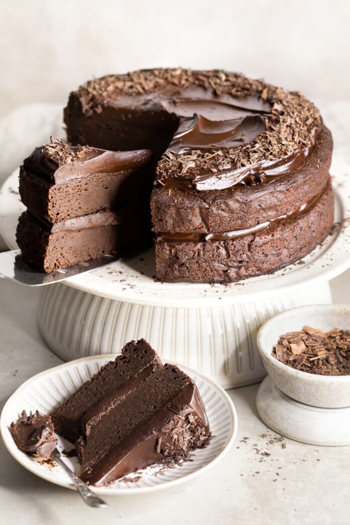 Vegan sweet potato chocolate fudge cake with a slice served on a plate