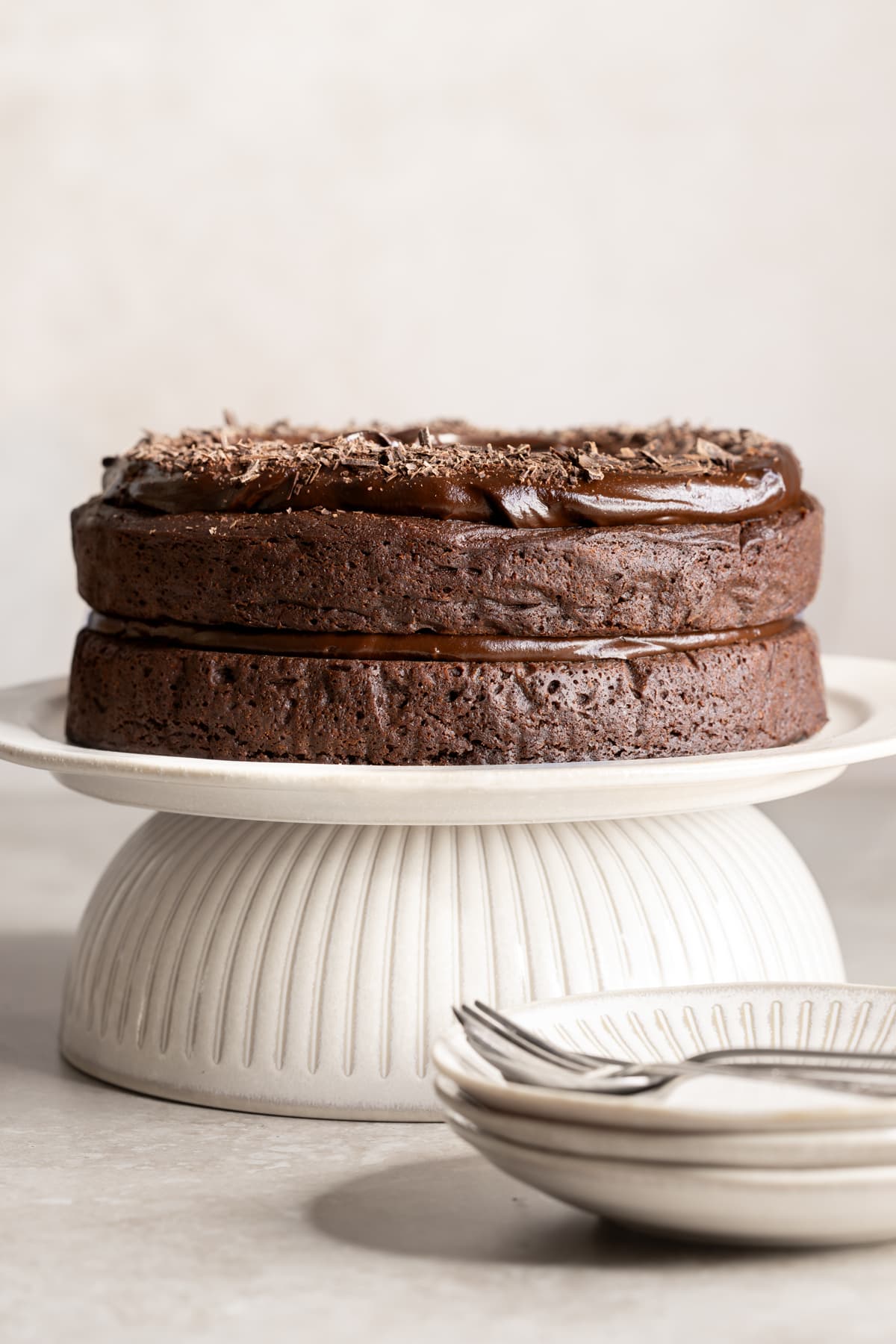 Double layer chocolate cake with frosting on a cake stand