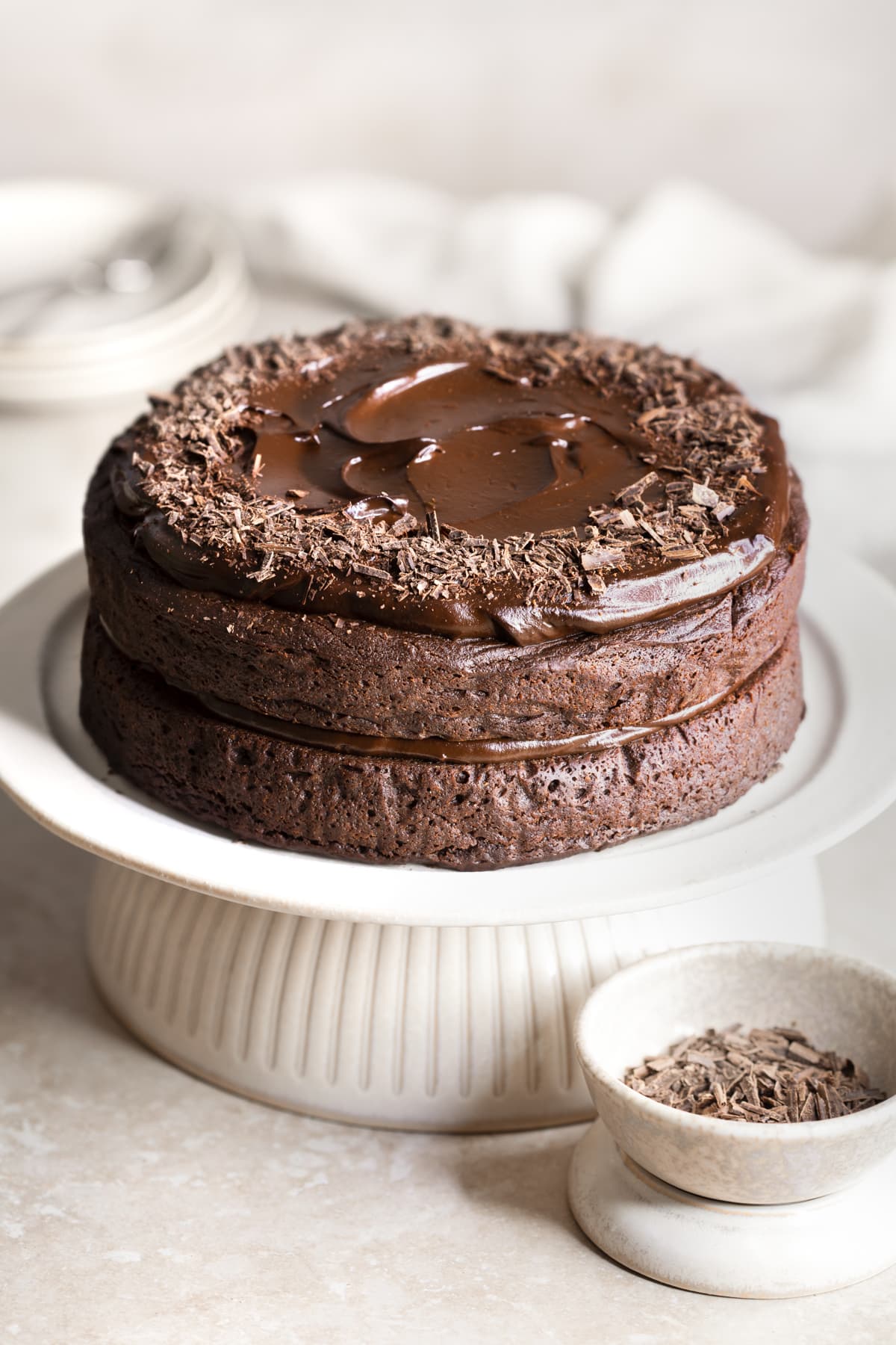 Chocolate fudge cake with frosting and decorated with grated dark chocolate