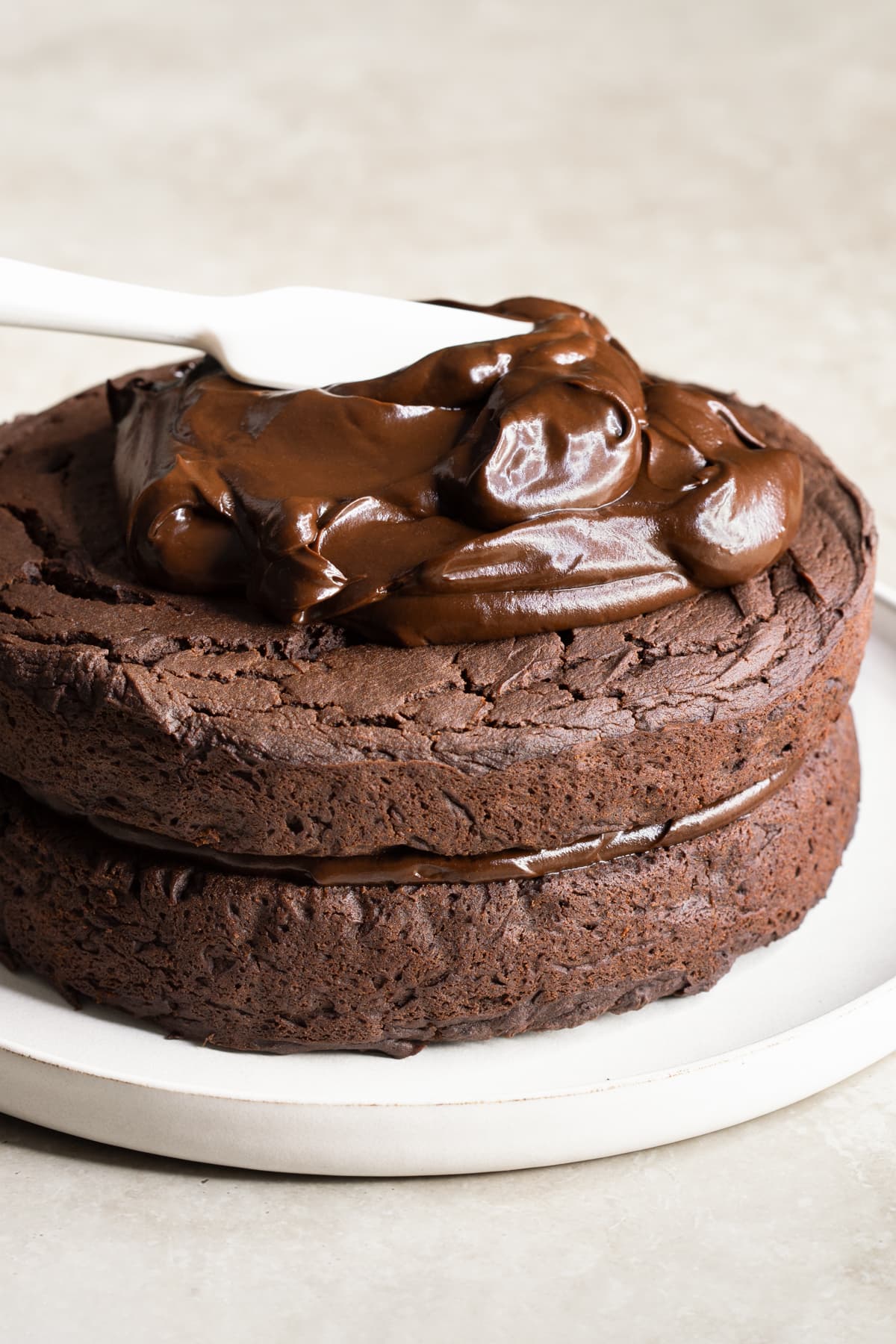 Chocolate frosting spread on top of a cake