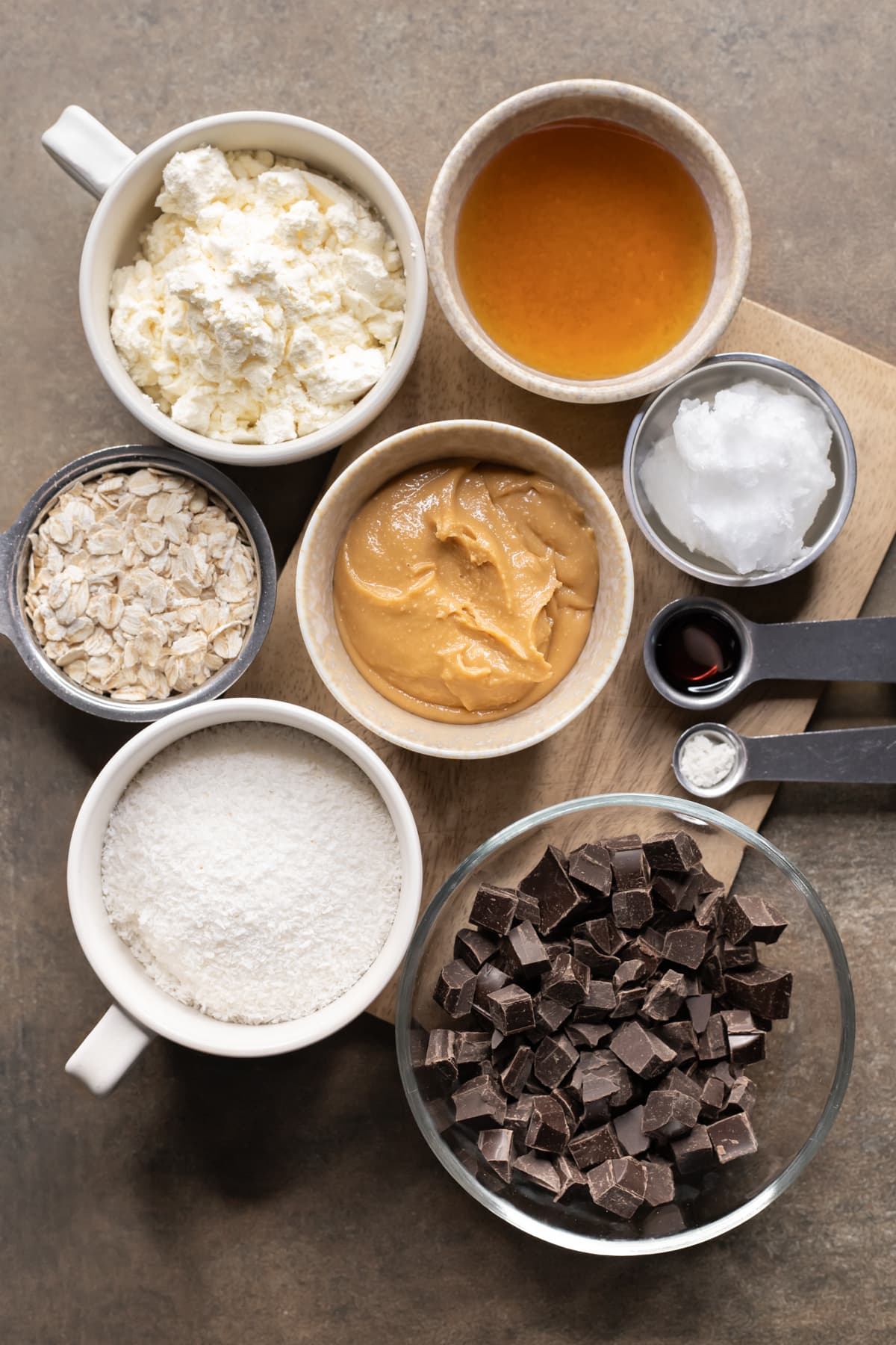 Ingredients for chocolate peanut butter protein slice divided into bowls