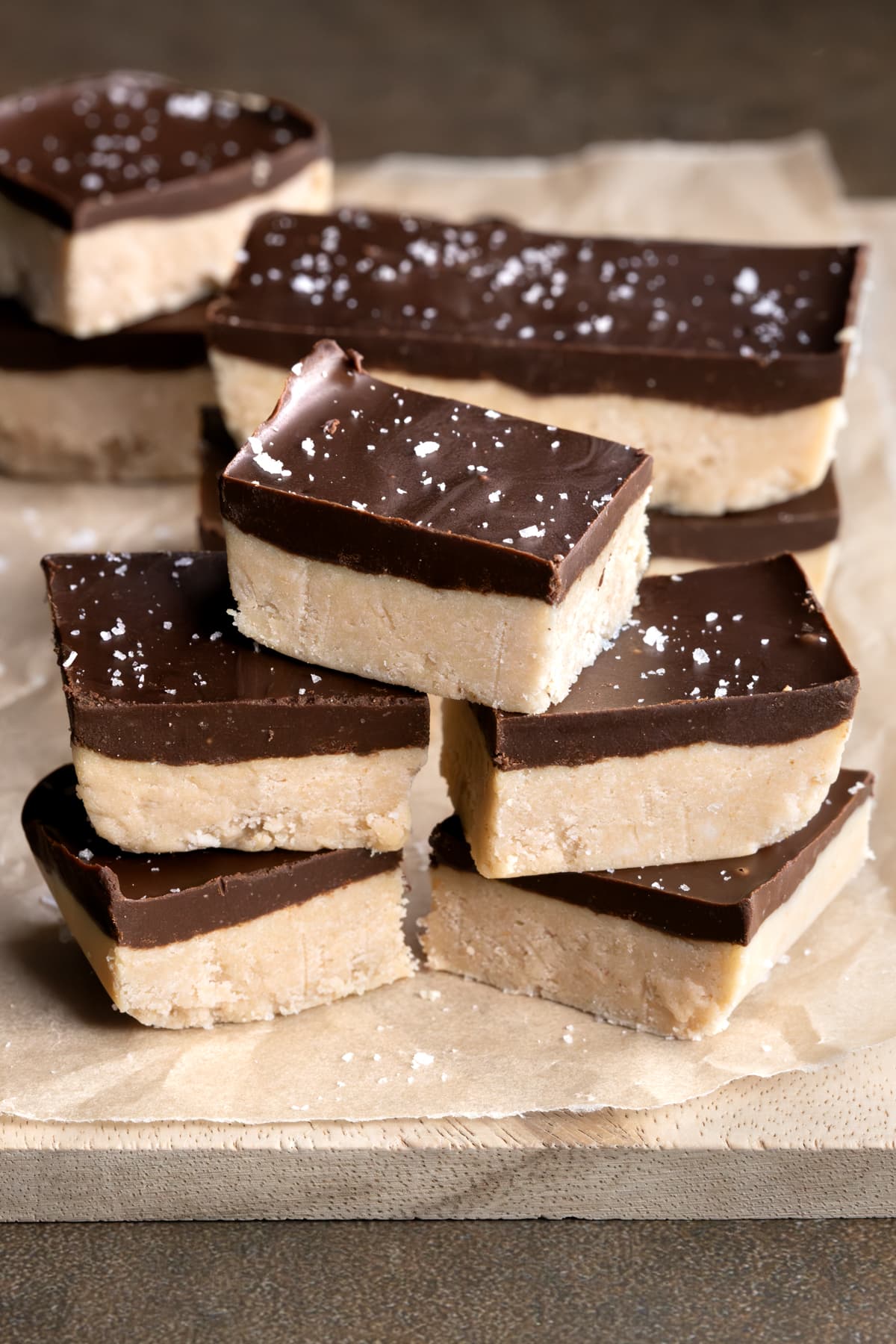 Peanut butter protein bars with a chocolate topping stacked on top of each other