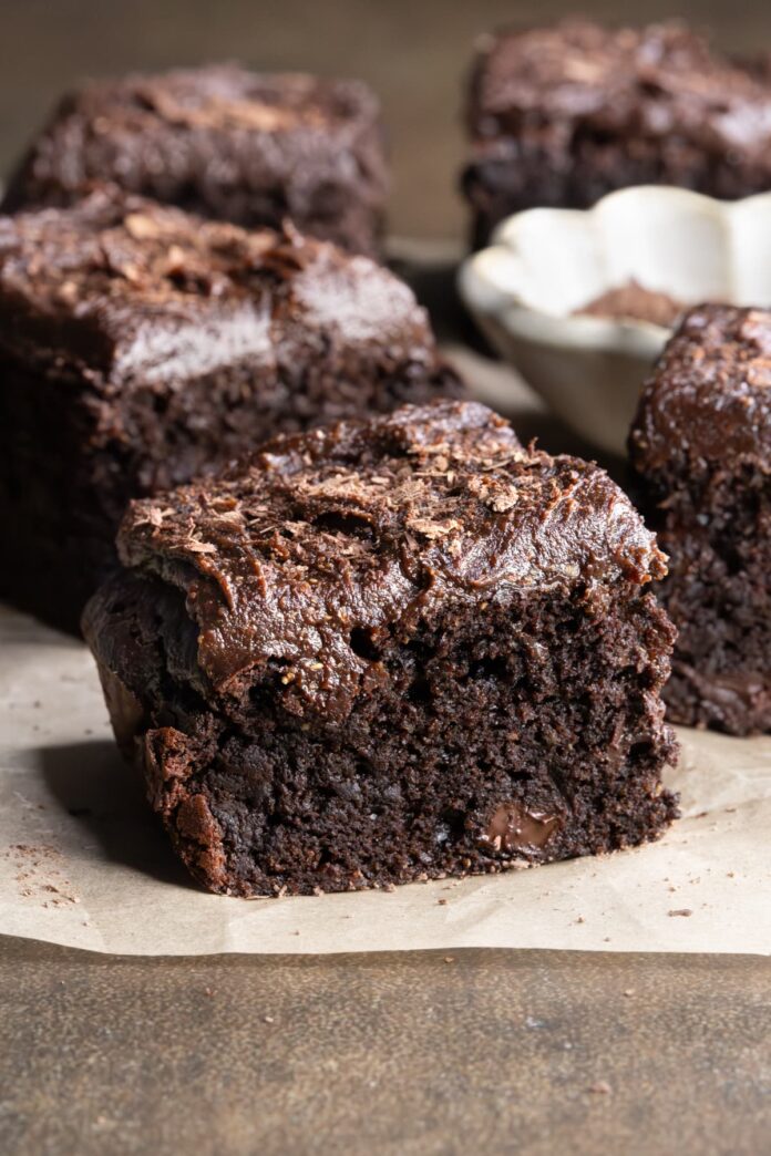 Zucchini brownies with chocolate frosting and sprinkled with shaved chocolate