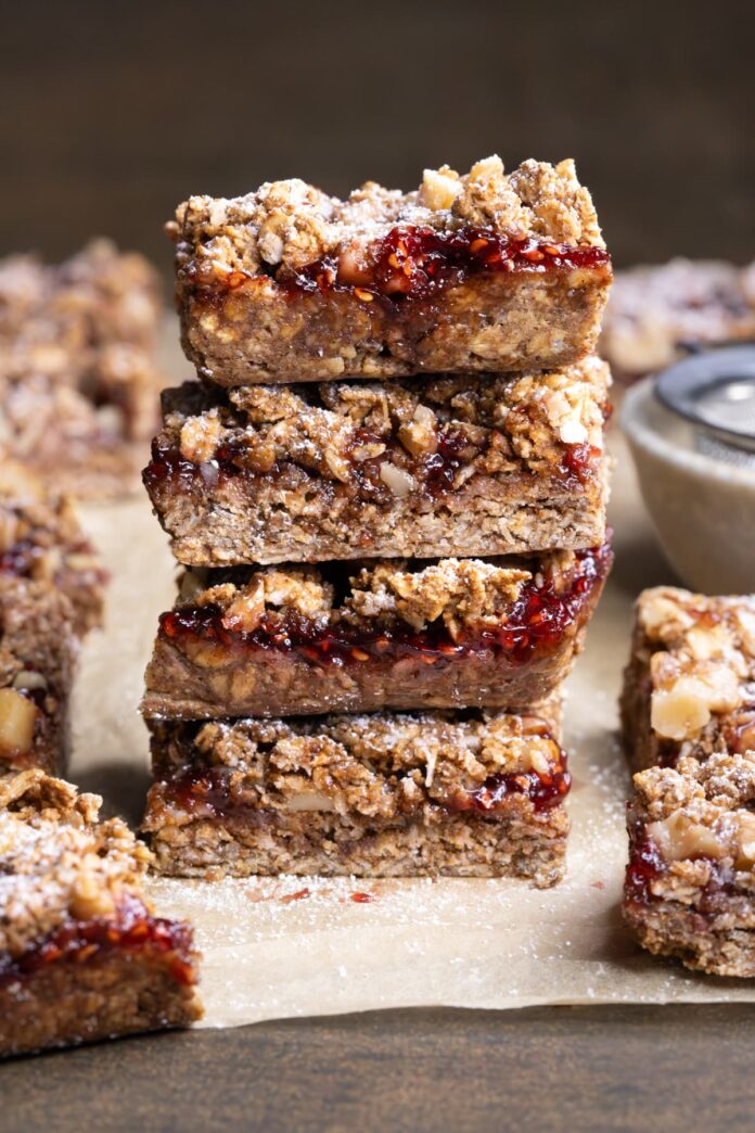 Oatmeal linzer crumble bars stacked on top of each other