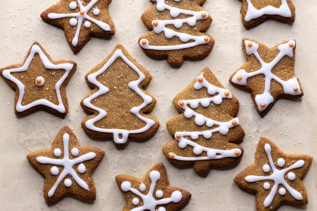 Decorated gingerbread cookies in the shape of Christmas trees and stars