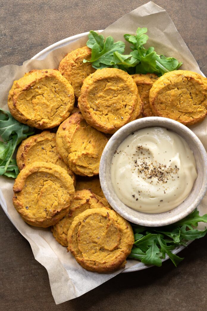 Baked chickpea fritters stacked on a plate