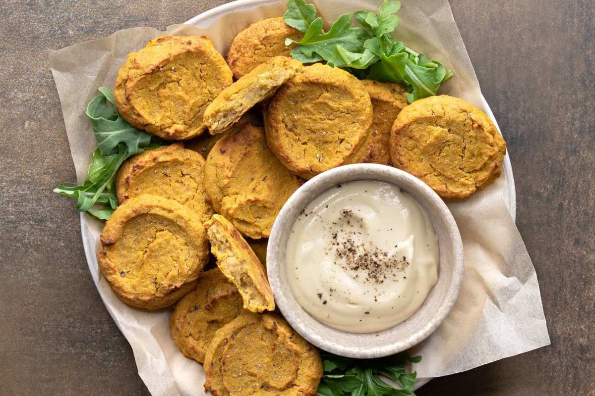 Chickpea fritters served on a plate with dipping sauce