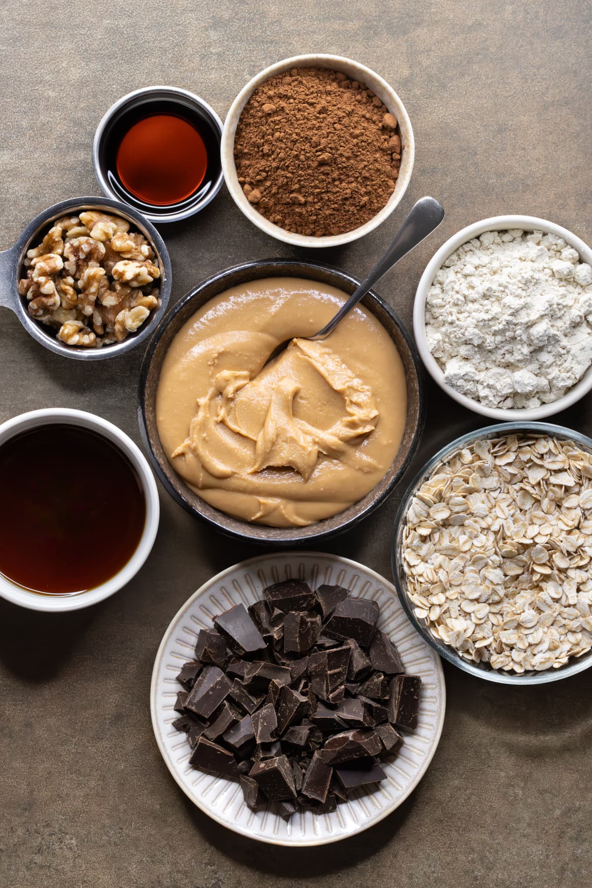 Ingredients for no-bake vegan brownies set out in bowls