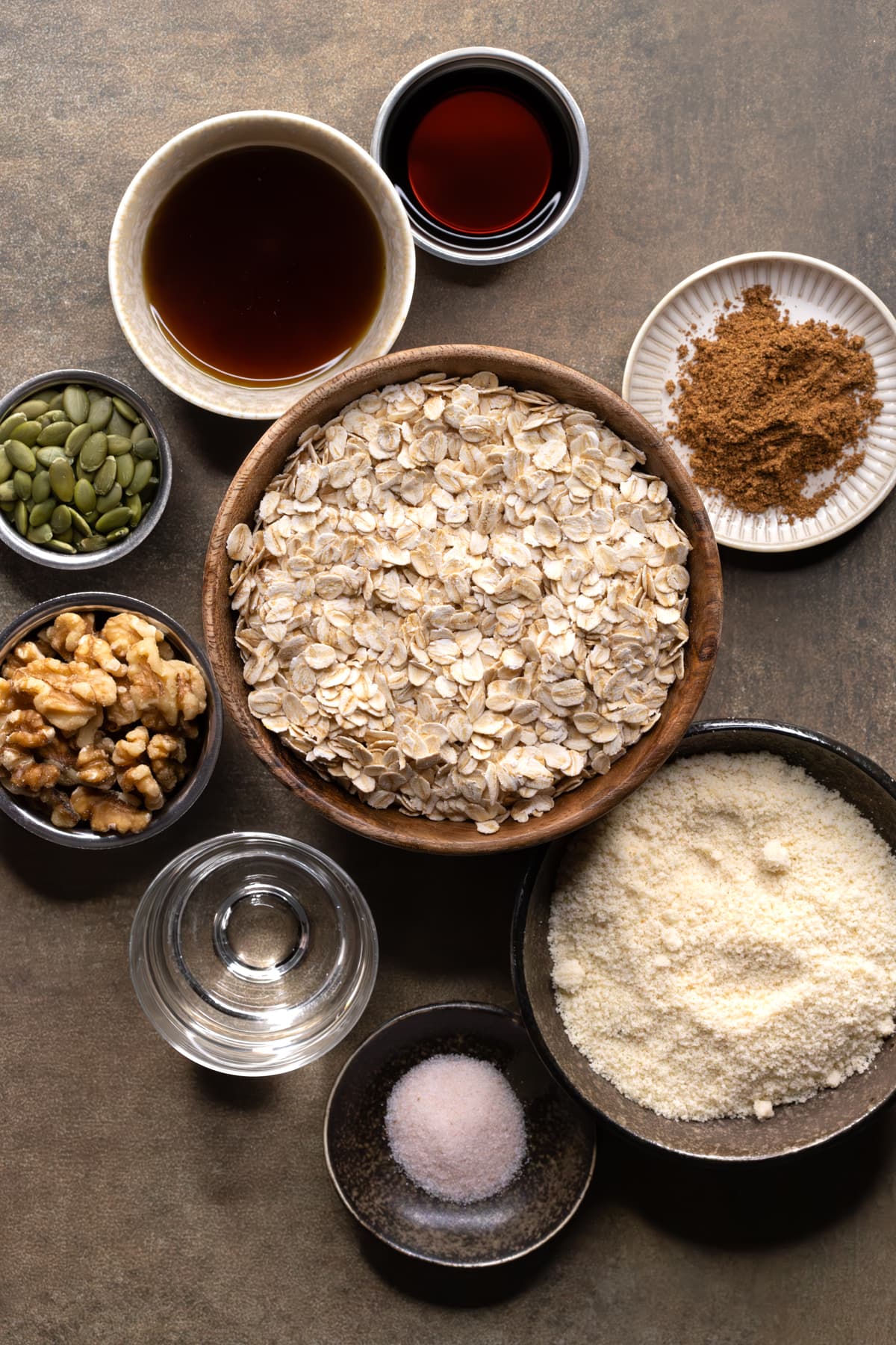 Ingredients for oil-free granola clusters arranged in bowls